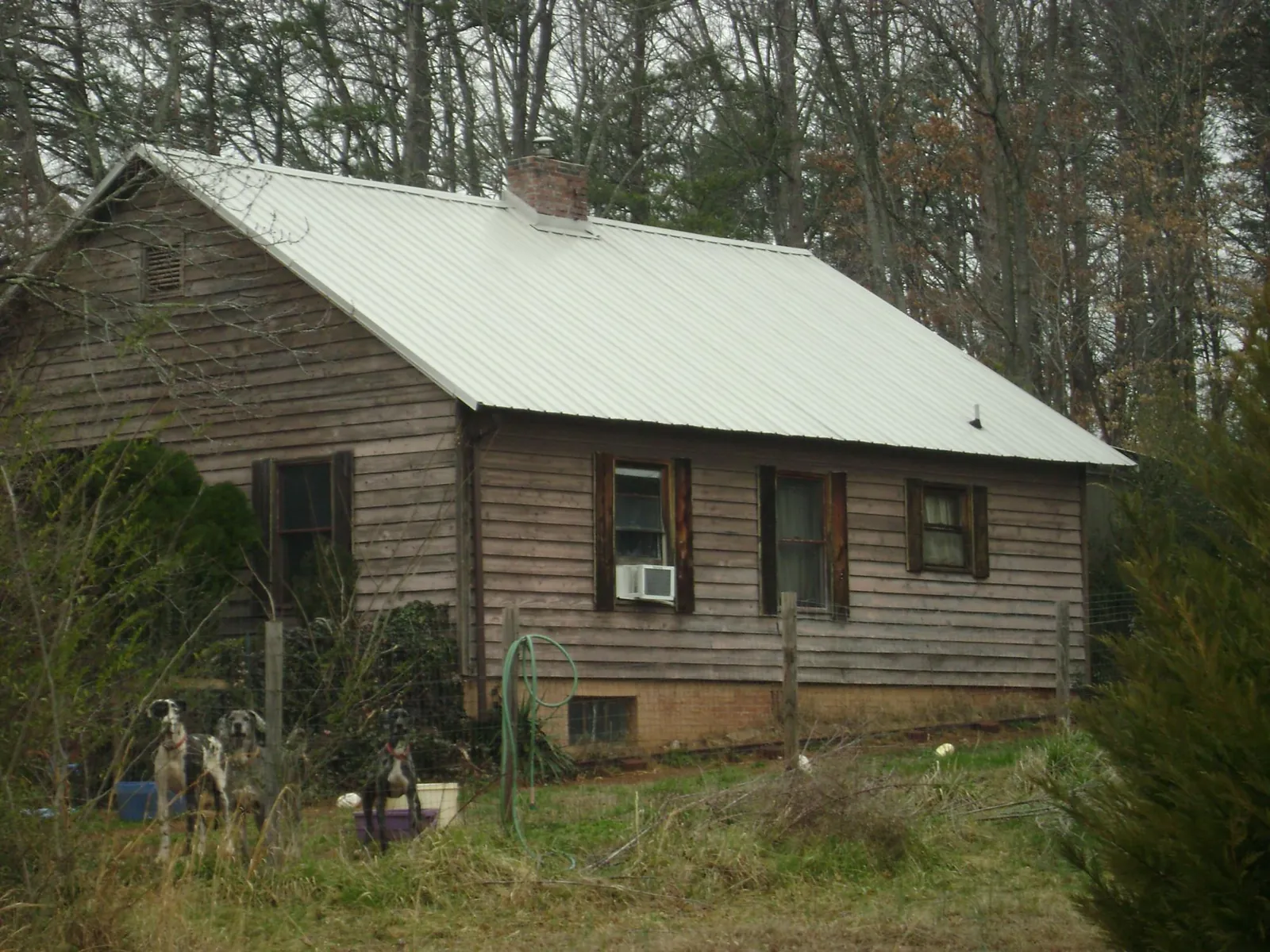 White metal roof on an old wood sided farmhouse, from a Metal Roof Installation job in Middleport
